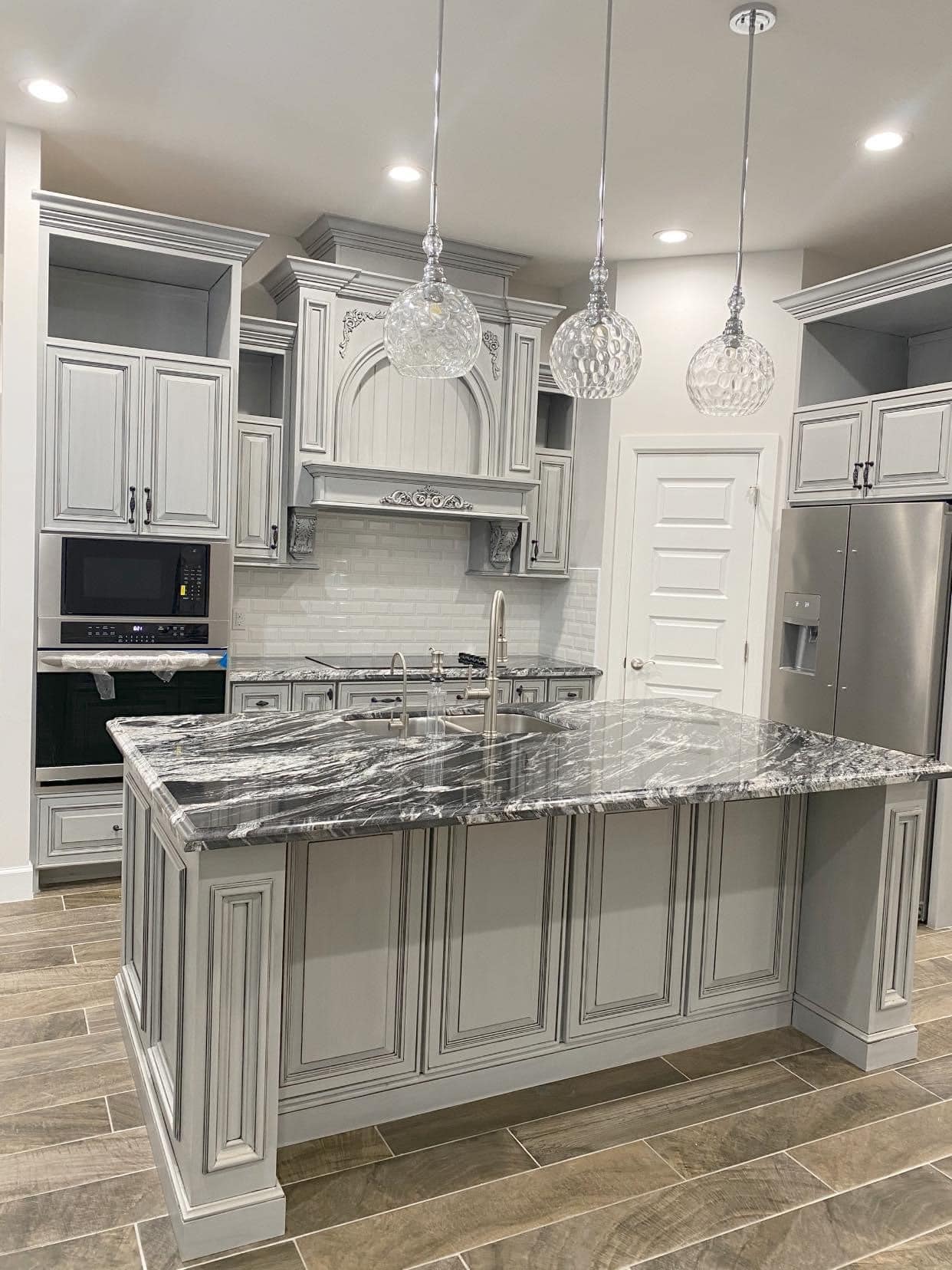 Custom Home Kitchen — Gray Raised-Panel & Marble Island